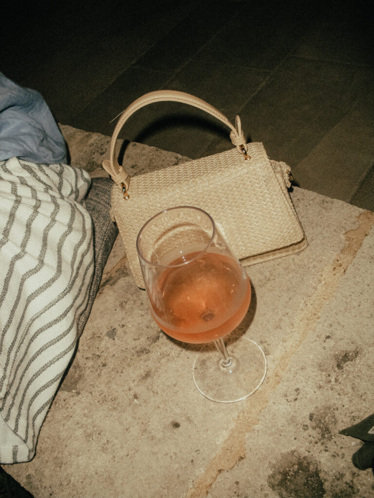 Overhead shot of a rosé setup with elegant glassware and linen backdrop