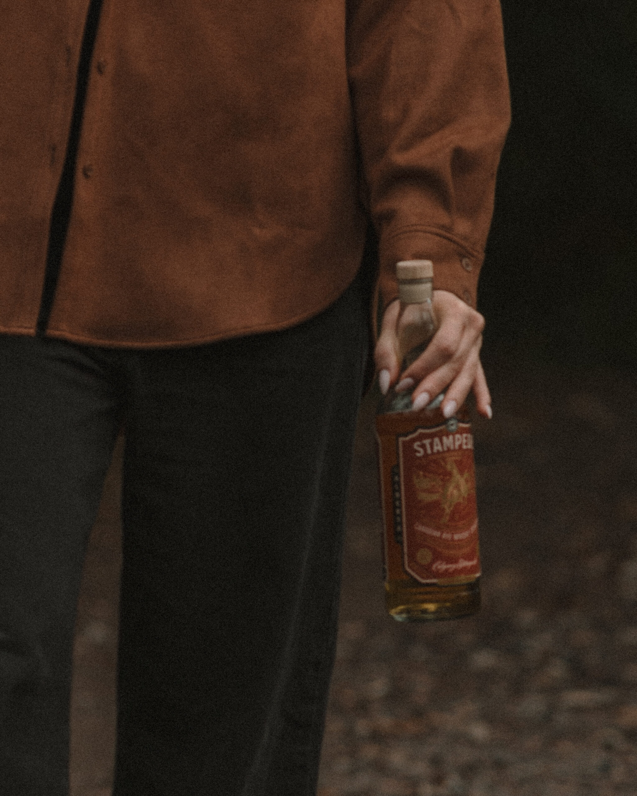 Lifestyle photography for whiskey brands article; in the image: eau claire distillery Stampede whisky, feat. Caroline West (talent), shot by Gretchen Reese, the Wine & Whiskey Photographer